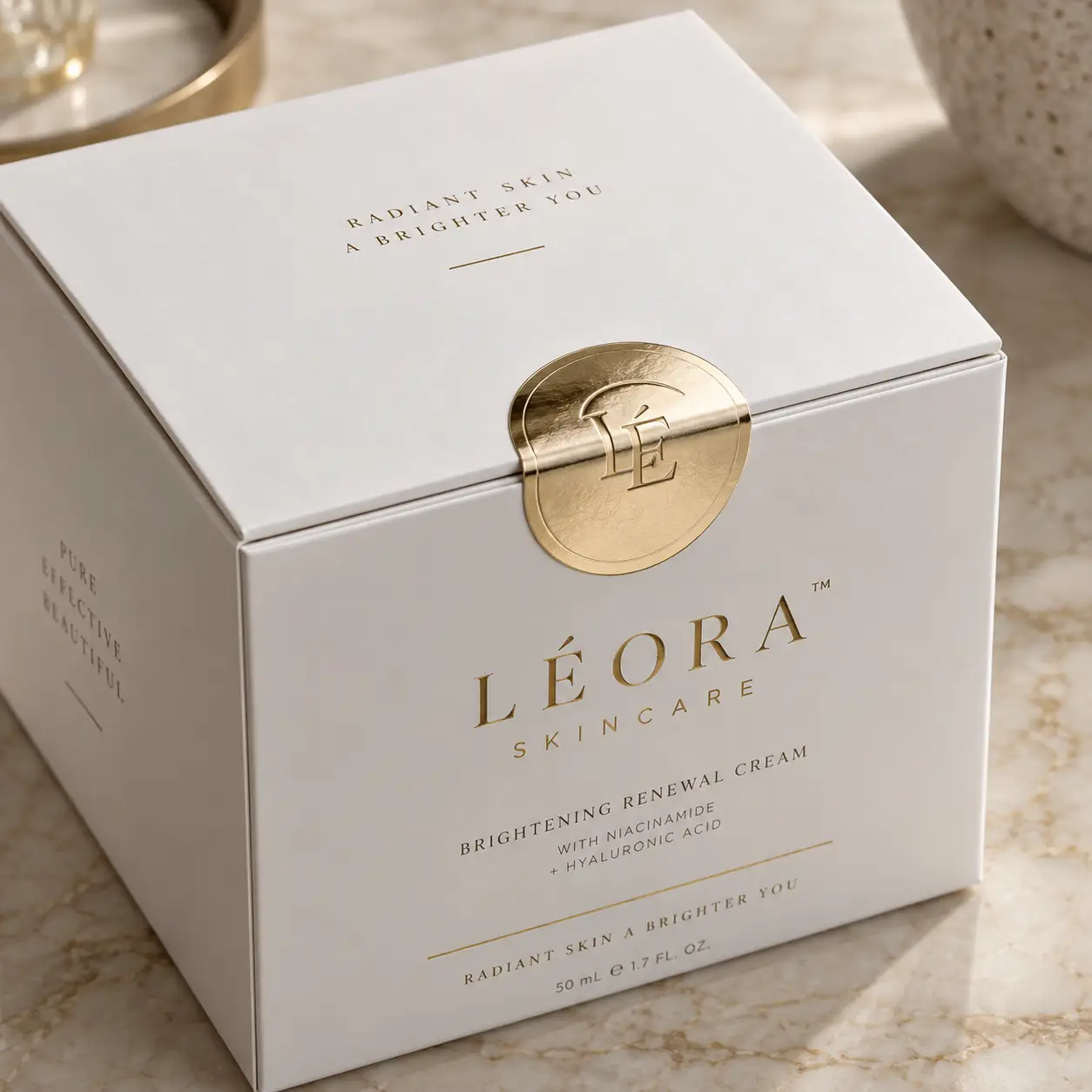 Léora Skincare Brightening Renewal Cream luxury white gold box packaging on marble surface, premium skincare product design