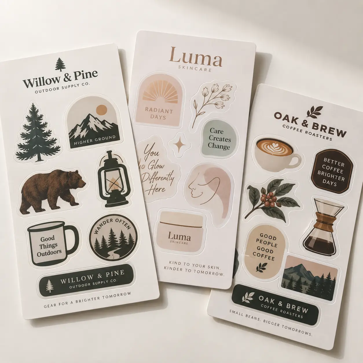 Three branded sticker sheets for Willow & Pine, Luma Skincare, and Oak & Brew featuring nature and coffee illustrations in earthy tones