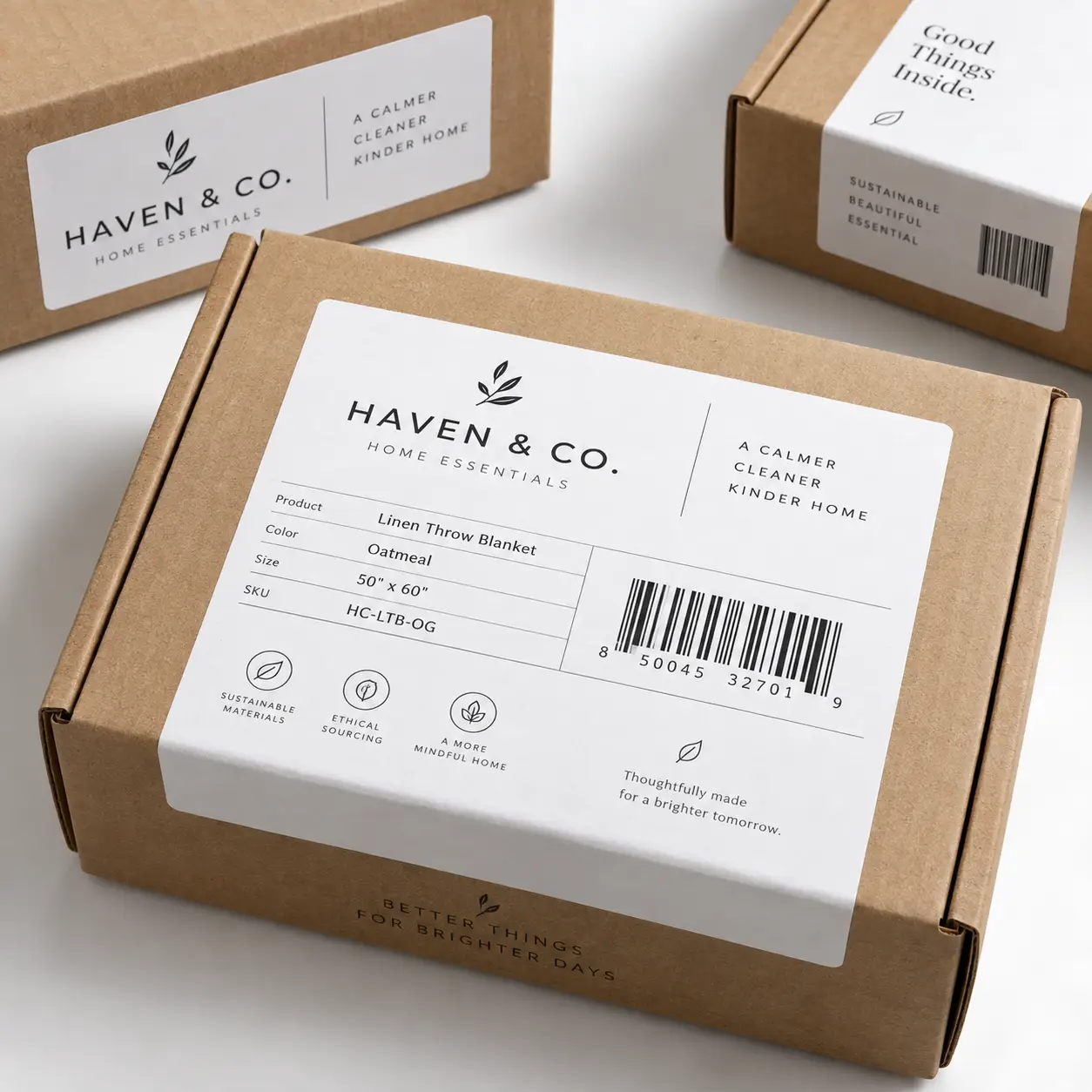 Kraft cardboard boxes with minimalist white product labels for Haven & Co. Home Essentials linen throw blanket sustainable packaging design