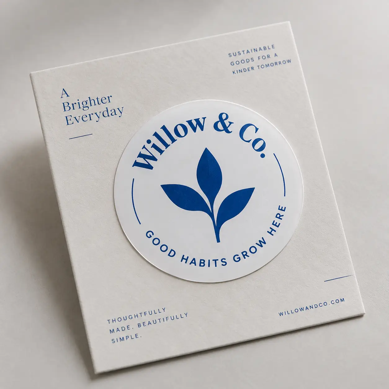White sustainable product box with blue Willow & Co circular sticker logo reading Good Habits Grow Here, minimalist eco-friendly packaging design