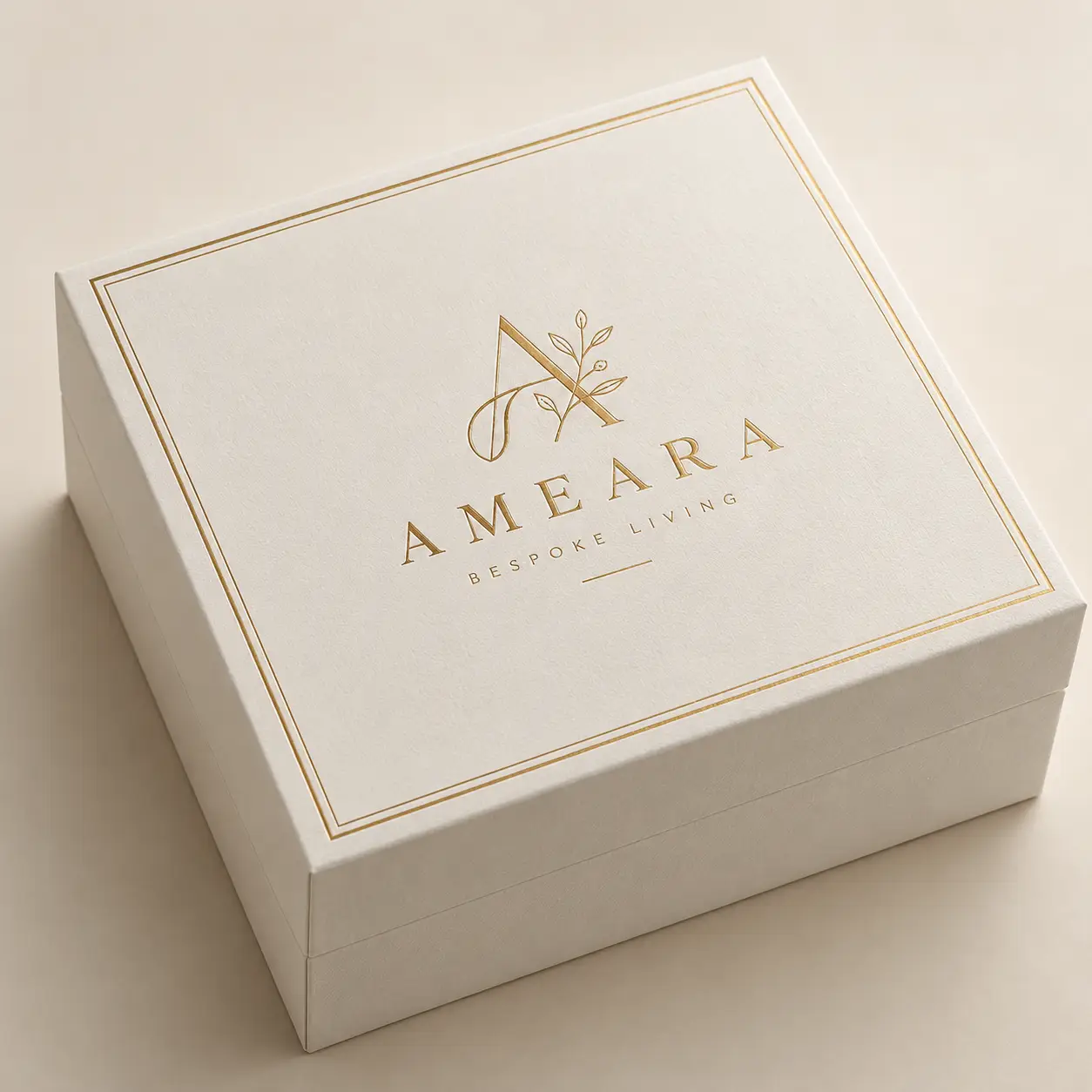 Luxury white gift box with gold foil Ameara Bespoke Living logo, elegant botanical monogram, premium custom packaging design